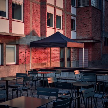 The black 3x3 m folding gazebo serves as an outdoor shelter on the terrace.