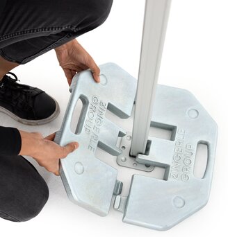 The woman attaches the 20 kg base plate to the folding gazebo.