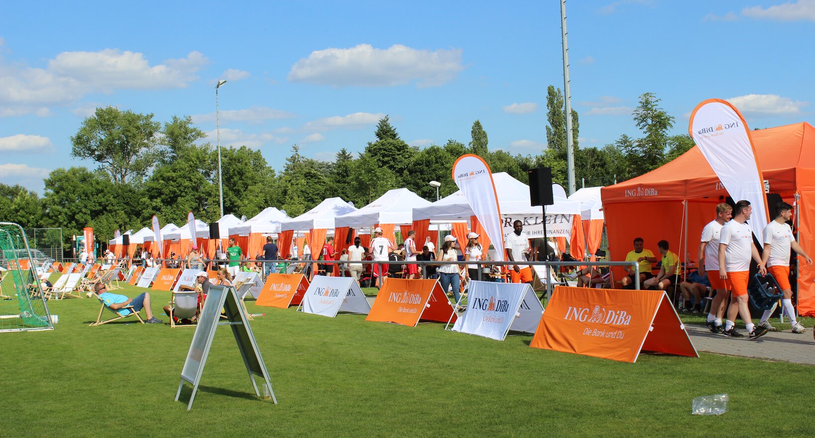 White and orange 6x3 gazebo with decorative pole cover tents and customised ING DiBa flags at sponsored sports event in Germany